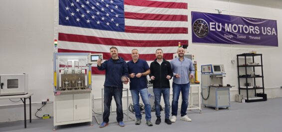 Team members from EU Motors standing in front of America flag