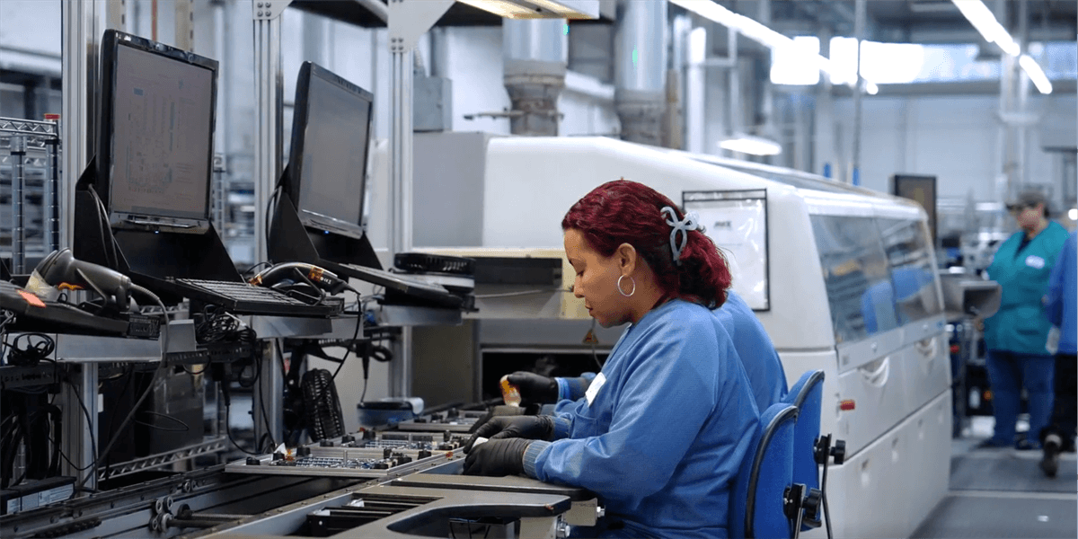 A woman working in an automated manufacturing facility